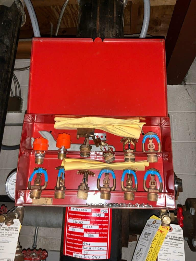 A spare sprinkler cabinet filled with different types of sprinklers, indicating that multiple samples may need to be selected.